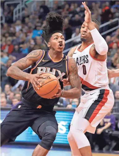  ?? PATRICK BREEN/THE REPUBLIC ?? Suns guard Elfrid Payton (2) drives the lane against the Trail Blazers’ Damian Lillard (0) during the first half at Talking Stick Resort Arena in Phoenix on Saturday night.