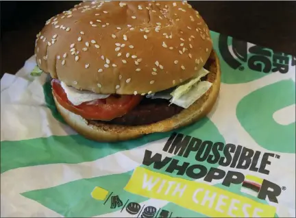  ?? BEN MARGOT — THE ASSOCIATED PRESS ?? In this Wednesday photo, an Impossible Whopper burger is photograph­ed at a Burger King restaurant in Alameda Burger King will soon offer its Impossible Whopper plant-based burger nationwide. The chain said the soy-based burger, made by Impossible Foods, will be available for a limited time at its 7,000 U.S. stores starting next week.