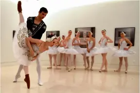  ?? — AFP ?? Dancers of Saint Petersburg ballet perform an act of Swan Lake ballet at Madrid's Fine Arts Museum on Monday. (Right) Dancers of Saint Petersburg ballet warm up before performing three extracts of Swan Lake.