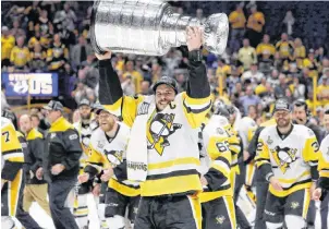  ?? AP PHOTO ?? Pittsburgh Penguins’ Sidney Crosby (87) celebrates with the Stanley Cup after defeating the Nashville Predators in Game 6 of the NHL hockey Stanley Cup Final in Nashville, Tenn., on June 11, 2017. Will the Pittsburgh Penguins create a dynasty with a...