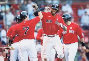  ?? Michael Dwyer / Associated Press ?? The Red Sox’s Xander Bogaerts, front right, celebrates his three-run home run with Christian Vazquez (7) during the fifth inning against the Angels on Saturday.