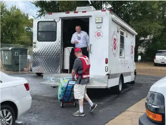  ?? Submitted photo ?? Captain Bryan Brinlee of The Salvation Army of Hot Springs loads a truck with hurricane relief supplies brought by Joseph Micucci, Social Services director.