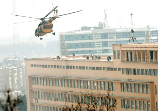 ??  ?? Afghan National Army (ANA) soldiers descend from helicopter on a roof of a military hospital during gunfire and blast in Kabul on Wednesday. (Reuters)