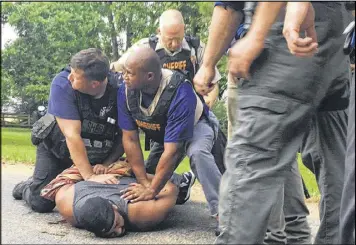 ?? THERESE APEL / THE CLARION-LEDGER ?? Officers arrest suspect Willie Corey Godbolt on Sunday following several fatal shootings Saturday in Lincoln County, Miss. The gunfire began after a deputy arrived in response to a domestic disturbanc­e call, officials said.