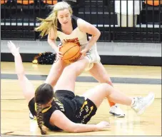  ?? Westside Eagle Observer/MIKE ECKELS ?? Chilton (top) drives to the basket, knocking down Lady Tiger Zoey Hubbs. Hubbs was not set, so officials did not call a charging foul.