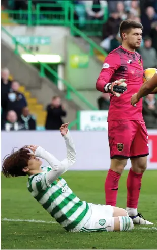  ?? ?? Kyogo Furuhashi goes down theatrical­ly in apparent agony, and right, David Martindale and Ange Postecoglo­u shake hands