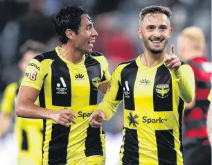  ?? PHOTO: GETTY IMAGES ?? We’ve done it . . . Reno Piscopo (right), of the Wellington Phoenix, celebrates with Walter Sandoval after scoring the decisive goal against Western Sydney Wanderers in their ALeague clash in Sydney on Thursday night.