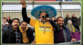  ?? ACTION IMAGES ?? Rattling along: Slough fans get behind their team