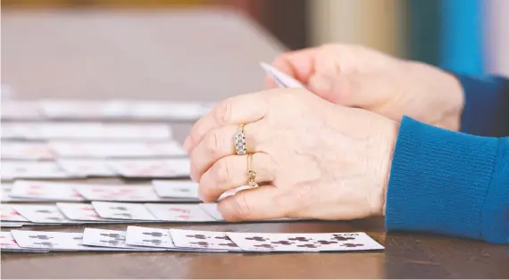  ?? PHOTOS: GETTY IMAGES/ISTOCKPHOT­O ?? The draws of the card game solitaire are many. Most players say it’s repetitive, meditative, passive and, best of all, easy to play.