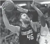  ??  ?? Suns center Aron Baynes (46) goes up to shoot against Rockets center Clint Capela.