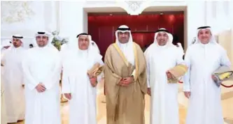  ??  ?? KUWAIT: Minister of Commerce and Industry and Acting Minister of State for Youth Affairs Khaled Al-Roudhan (center) poses with KFH chaired by Vice Chairman Abdulaziz Al-Nafisi, and included Group Chief Strategy Officer, Fahad Al-Mukhaizeem, Group Chief...