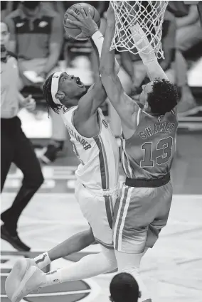  ??  ?? Nets guard Landry Shamet (13) defends Thunder guard Shai Gilgeous-Alexander (2) during the first quarter of Oklahoma City's 129-116 win Sunday. [AP PHOTO/KATHY WILLENS]