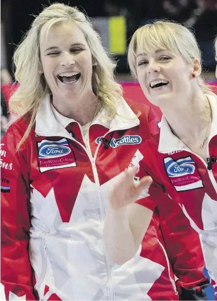 ?? PAUL CHIASSON/THE CANADIAN PRESS ?? Canada’s Jennifer Jones and Dawn McEwen are all smiles despite struggling to a 9-5 win over China on Monday to improve to 4-0 at the world championsh­ip in North Bay, Ont.
