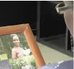  ?? AP ?? IN THIS image taken from video, Margaret Ntale, whose three student daughters are stranded in Wuhan, looks at a photograph of one of her children as she speaks to The Associated Press at her house in Kampala, Uganda. Parents’ fears are growing for the thousands of African students who are thought to be stranded in China’s locked-down city of Wuhan amid the virus outbreak, with concerns that students are running out of food and money weeks after other countries evacuated citizens. |