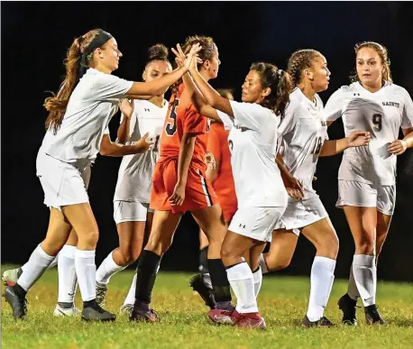  ?? Photo by Jerry Silberman / risportsph­oto.com ?? St. Raphael attacker Britney Handrigan (4, left) is congratula­ted by a teammate after she scored the Saints’ lone goal in Thursday night’s 1-1 tie with West Warwick. St. Raphael is back at McKinnon-Alves this afternoon to take on undefeated Pilgrim at 4.