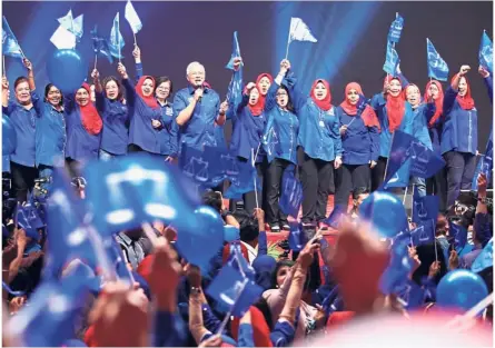  ??  ?? Full of confidence: Najib and Wanita Barisan leaders rallying their members during the launching of the BN Women Manifesto for GE14 at Putra World Trade Centre in Kuala Lumpur.