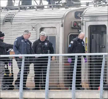  ?? BRIAN CASSELLA/CHICAGO TRIBUNE ?? Chicago police officers investigat­e the scene where a 33-year-old man was shot by a Northern Indiana Commuter Transporta­tion District police officer on a South Shore Line train at the Hegewisch station on Thursday.