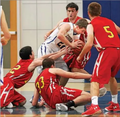  ?? ROBERT J. GURECKI — DAILY TIMES. ?? Springfiel­d’s Kyle Sullivan finds himself surrounded by Haverford defenders, clockwise from right, Connor Gulfoil, Pat Corbett, Matt McMahon and Jack Donaghy, during a Central League game Tuesday night. Sullivan and the Cougars claimed a 48-38 victory.