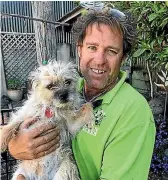  ??  ?? Nelson man Mike Gafa with his border terrier, Ruby, which was rescued after being swept out to sea.