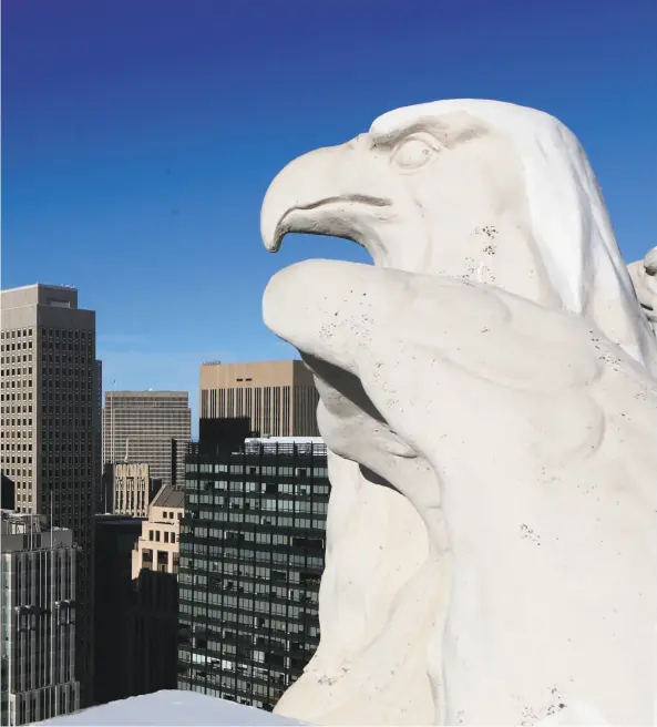  ?? Beck Diefenbach / Special to The Chronicle 2012 ?? Above: One of several fierce-looking eagle statues perches atop the Timothy Pflueger-designed Pacific Telephone Building at 140 New Montgomery, which was finished in 1925 and was the tallest in the city at a towering 435 feet.
Far left: Another detail...