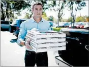  ?? SANDY HUFFAKER/GETTY ?? Rep. Duncan Hunter takes pizzas to campaign workers. Hunter won despite facing federal charges of wire fraud.