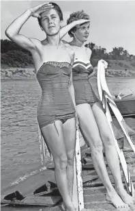  ?? THE COMMERCIAL APPEAL FILES ?? Far Horizons come to mind in July 1955 as Mrs. Scott Dodds (Left) and Mrs. Jane Coll prepare for a 244-mile Mississipp­i River trip from Cairo, Ill. to McKellar Lake on water skis. The young Memphis mothers each have two children. They plan to make the trip on August 20.