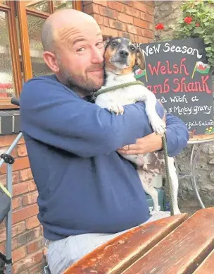  ??  ?? Richard Davies with his family’s dog Oscar and, below, with three-year-old son Rory