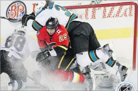  ?? Ted Rhodes, Calgary Herald ?? David Moss is squeezed out of the play in front of the San Jose Sharks net in a recent game.