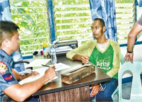  ?? SUNSTAR / ALAN TANGCAWAN ?? "NOT FEELING
WELL." While he was being questioned after his arrest, Saad Samad Kiram (right) reportedly asked to go to the bathroom several times. He had complained of stomach pains and diarrhea. On his way to jail, he allegedly used the same excuse...