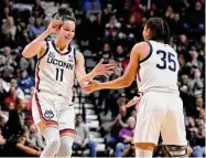  ?? Jessica Hill/Associated Press ?? UConn’s Lou Lopez Senechal (11) celebrates with Azzi Fudd during the first half against Georgetown in the quarterfin­als of the Big East Conference tournament at Mohegan Sun Arena on Saturday in Uncasville.