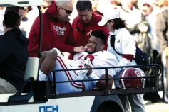  ?? AP Photo/Rogelio V. Solis ?? ■ Alabama quarterbac­k Tua Tagovailoa (13) is carted off the field after getting injured in the first half against Mississipp­i State on Saturday in Starkville, Miss.