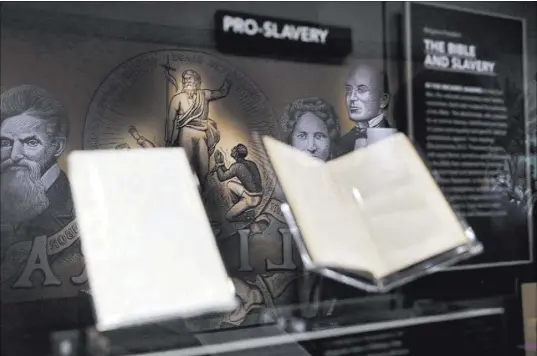  ?? Jacquelyn Martin The Associated Press ?? An exhibit on slavery in the U.S is displayed inside the Museum of the Bible in Washington. The museum opened Saturday.