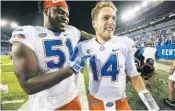  ?? DAVID STEPHENSON/AP ?? Florida OL Antonio Riles, left, celebrates with Luke Del Rio after a last-minute comback against Kentucky last week.