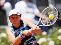  ?? ?? Iga Swiatek of Poland returns the ball to Aryna Sabalenka of Belarus during their semifinal match at the Italian Open tennis tournament, in Rome. (AP)