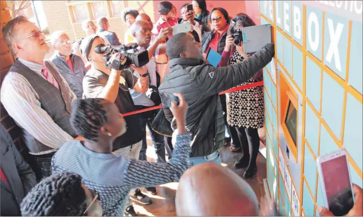  ??  ?? A delegate demonstrat­ing how to use and collect medication from the Pelebox at the launch on July 11 2019.