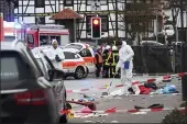  ?? UWE ZUCCHI — DPA ?? Police and rescue workers stand next to the scene of an accident in Volkmarsen, central Germany, on Monday.