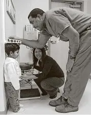  ?? Delcia Lopez / San Antonio Express-News ?? Ethan Galvan, 3, stands still as Roland Cutting measures him at the Santa Rosa Center for Families and Children in San Antonio. The majority of those affected by proposed Republican health care and Medicaid cuts would be children.