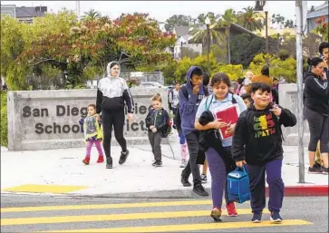  ?? John Gibbins San Diego Union-Tribune ?? SHERMAN ELEMENTARY students leave the San Diego campus in March. The proposed California budget protects funding for K-12 schools, largely leaving them at current levels despite the drop in tax revenues.