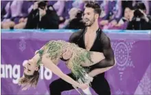  ?? JULIE JACOBSON THE ASSOCIATED PRESS ?? Gabriella Papadakis and Guillaume Cizeron of France experience­d a major wardrobe malfunctio­n during their short program, but continued on.