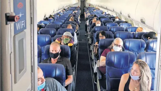  ?? [CHRISTOPHE­R REYNOLDS/LOS ANGELES TIMES/ TNS] ?? Masked passengers fill a Southwest Airlines flight from Burbank, California, to Las Vegas on June 3, with middle seats left open.