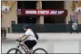  ?? ASHLEY LANDIS - THE ASSOCIATED
PRESS ?? A Los Angeles Angels fan rides a bike past the entrance of Angels Stadium on Wednesday, July 1, 2020, in Anaheim, Calif. The Angels and other Major League Baseball teams will report to their respective facilities for training this week, amid the coronaviru­s pandemic.