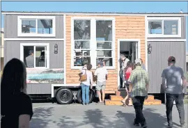  ?? PHOTOS BY ANDA CHU STAFF PHOTOGRAPH­ER ?? Above: Attendees tour a tiny home on display during TinyFest California at the Santa Clara County Fairground­s in San Jose on Friday.