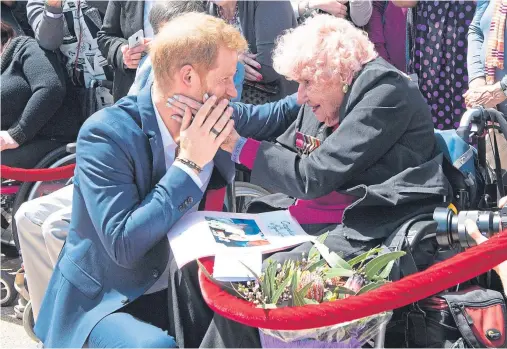  ??  ?? WELL-WISHERS: Harry is greeted again by 98-year-old Daphne Dunne, who he also met during previous visits to Australia in 2015 and 2017