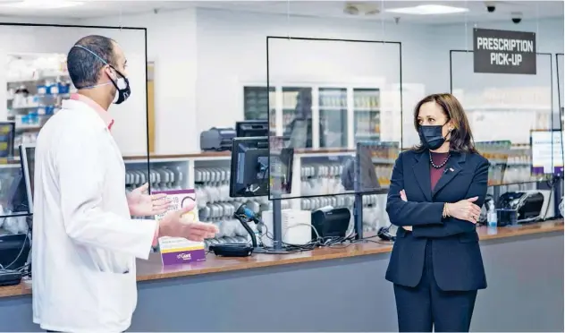  ?? Agence France-presse ?? ↑
US Vice President Kamala Harris speaks with pharmacist Samir Balile during a visit to the pharmacy of a Giant Foods grocery store in Washington DC on Thursday.