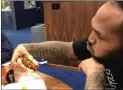  ?? The Associated Press ?? In this image made from video, Tennessee Titans defensive end Jurrell Casey eats a vegetarian cheeseburg­er provided by chef Charity Morgan, wife of Titans linebacker Derrick Morgan.