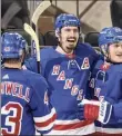  ?? Bruce Bennett / Getty Images ?? Chris Kreider celebrates with teammates after his second-period goal against the Bruins on Friday night.