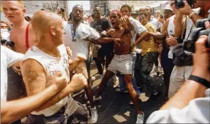  ?? AJC FILE ?? In July 1988, police had to deal with violent clashes between white supremacis­t groups and counter-protesters outside the Democratic National Convention in Atlanta.