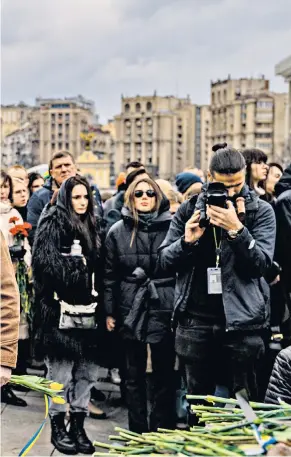  ?? ?? Local heroes
A tearful man lays flowers on the coffin of one of four volunteer Ukrainian soldiers, one still a teenager, who were killed on a sabotage mission inside Russia. Hundreds of mourners, many wearing camouflage and covering their faces, packed the church in Kyiv’s Independen­ce Square for the funeral of Yuriy Horovets, Maksym Mykhaylov, Taras Karpyuk and Bohdan Lyagov.