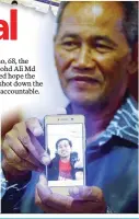  ??  ?? (Far left) Our previous reports on flight MH17.
(Above) A family member of a passenger at the memorial in Putrajaya yesterday.
(Left) Md Salim with a picture of his son Mohd Ali, who perished in the tragedy.