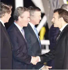  ??  ?? Macron (right) greets Australian Minister for Defence Industry Christophe­r Pyne upon his arrival at Sydney’s internatio­nal airport. — AFP photo